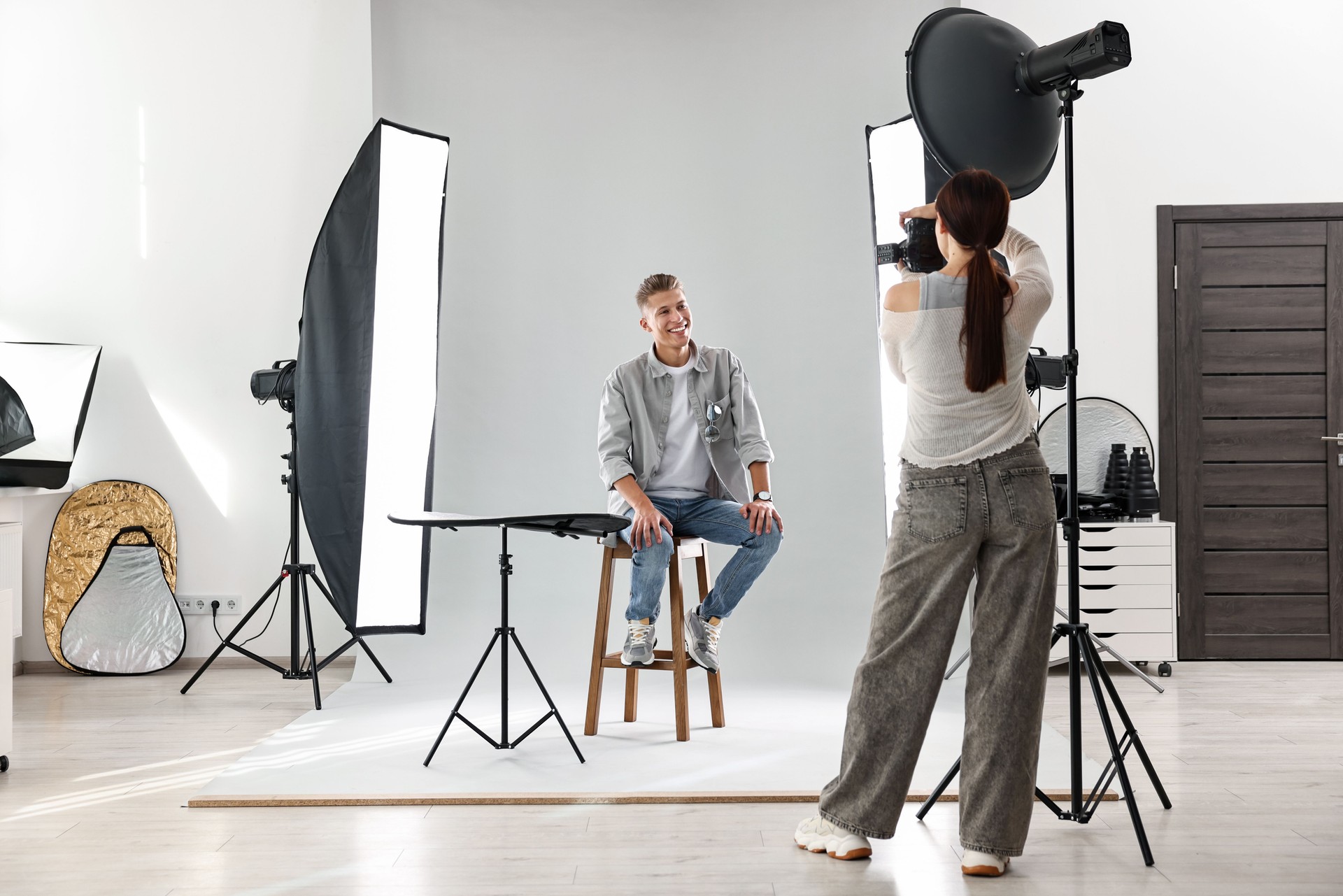 Photographer working with model in professional photo studio